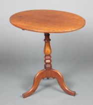 An oval mahogany snap top wine table raised on a pillar and tripod base 72cm h x 59cm w x 51cm d The
