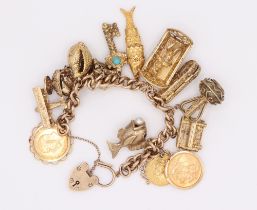 A 9ct yellow gold charm bracelet comprising 11 9ct charms, 2 sovereigns 1927 and 1958 and a half
