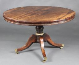 A Regency rosewood, inlaid brass circular breakfast table, raised on a turned column and tripod base