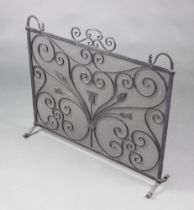 A wrought iron and mesh blacksmith made spark guard with thistle decoration 74cm h x 87cm w x 20cm d