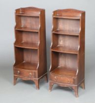 A pair of Georgian style waterfall bookcases fitted 3 shelves, the bases fitted a drawer, raised