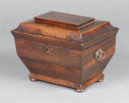 A Georgian rosewood twin compartment tea caddy of sarcophagus form with hinged lid and ring drop