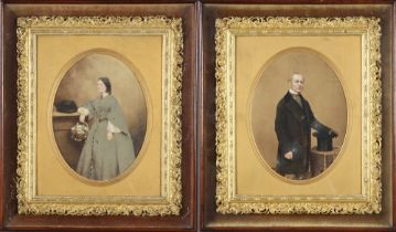 A pair of Victorian over painted prints of a lady and gentleman, oval, contained in fancy gilt