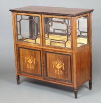 An Edwardian inlaid mahogany display cabinet with mirrored back and plush interior, enclosed by