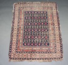 A blue, red and white ground Persian rug, decorated numerous medallions within a central medallion