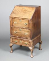 A Georgian style mahogany bureau, the fall front revealing a well fitted interior with pigeon