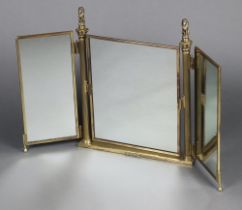 A 1950's gilt metal triple plate dressing table mirror with lion finials 55cm h x 55cm w Some