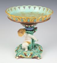 A 19th Century Wedgwood Majolica centre piece in the form of a kneeling cherub 22cm Chip to rim