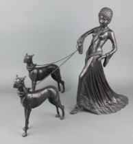 An Art Deco style bronze figure group of a standing lady leading 2 Great Danes 44cm x 31cm x 16cm