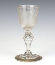 An 18th Century glass goblet engraved with a scene of lady and gentleman with an angel before a