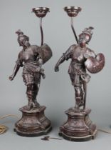 An impressive pair of Victorian spelter figures of standing warriors, raised on shaped bases,