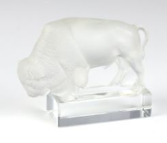 A modern Lalique opalescent figure of a bison standing on a rectangular base, etched lowercase marks