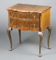 A Queen Anne style quarter veneered and crossbanded chest of serpentine outline fitted 2 long