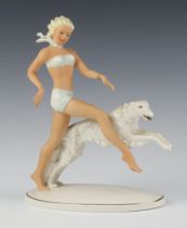 A German art deco style Schaubach Kunst figure of a lady with hound 24cm