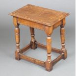 A 1920's rectangular oak joined stool raised on turned and block supports with box frame stretcher