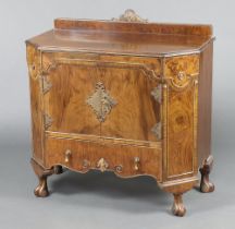 A 1930's Italian style walnut side cabinet/wash stand with raised back carved a shell, fitted a