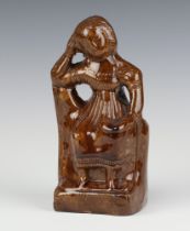 A 19th Century brown glazed money bank in the form of a seated lady 20cm Minor chips to the base