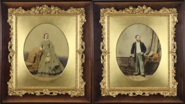 A pair of oval Victorian photographs of a lady and gentleman, over painted in fancy gilt frames 26cm