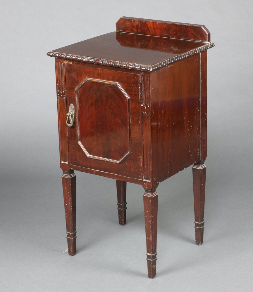 A Chippendale style carved mahogany bedside cabinet with raised back, cupboard enclosed by a