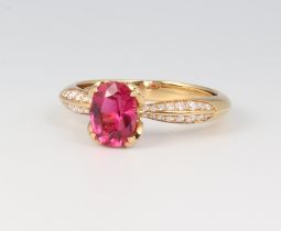 Kat Florence, an 18ct yellow gold oval cut red tourmaline ring approx. 1.13ct, the shoulders with