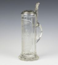 An early 20th Century German cut glass stein with hunting scene and faceted lid with pewter mounts