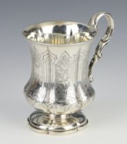A Victorian repousse silver baluster mug with engraved monogram and S scroll handle London 1849, 178