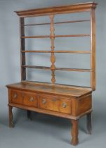 An 18th Century oak dresser base fitted 2 long drawers with an associated raised back with moulded