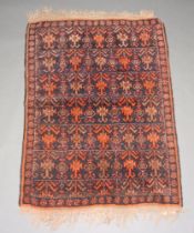 A black, brown and orange ground Afghan rug with all over geometric design 119cm x 86cm The rug does