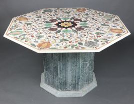 A 20th Century octagonal Indian inlaid specimen marble pedestal table, raised on a carved hard stone