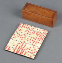 Twenty eight bone and ebony miniature dominoes contained in a mahogany box, the base marked Albert