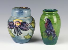 A modern Moorcroft squat shaped pale blue jar and cover decorated with clematis 10cm, a ditto