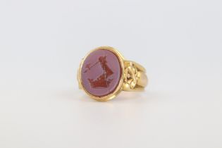 A yellow metal 18ct hardstone signet seal ring size P, 10.2 gramsThe stone is cracked