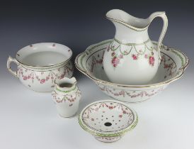 An Edwardian wash stand set decorated with roses comprising wash jug, bowl, tooth brush holder,