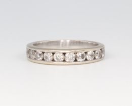 A white metal 18ct half eternity ring set with brilliant cut channel set diamonds approx. 0.7ct,