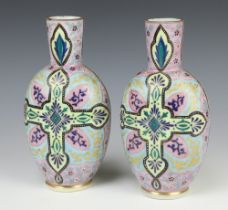 A pair of Victorian painted glass vases decorated with a cross and leaves 22cm