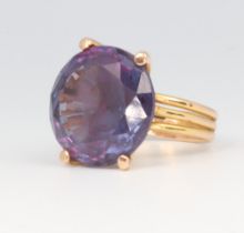 A yellow metal brilliant cut amethyst ring 9.9 grams, size J 1/2