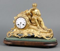 A 19th Century French mantel clock with enamelled dial, Roman numerals, contained in a gilt
