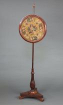 A Victorian rosewood pole screen with circular bead work banner decorated a parrot within floral