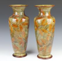 A pair of Royal Doulton oviform vases with flared necks decorated with leaves 40cm