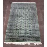 A green and black ground Bokhara rug with 78 octagons to the centre within a multi row border