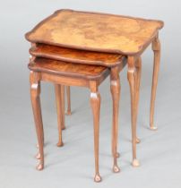 A nest of 3 Queen Anne style figured walnut coffee tables with quarter veneered tops raised on