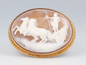 An oval yellow metal 9ct carved cameo brooch with a chariot scene