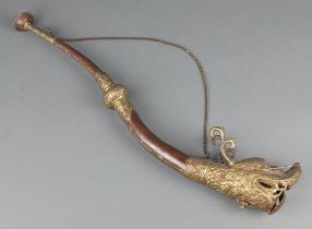 A "Tibetan" copper and embossed brass horn in the form of a dragon 52cm