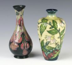 A modern Moorcroft blue ground baluster vase with waisted neck 17cm, a ditto cream ground vase