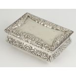 A Victorian rectangular silver table top snuff box decorated with flowers and vacant cartouche