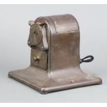 Sloan's, a desk mounted pencil sharpener 18cm h x 17cm w x 16cm d Hinge to the top is broken