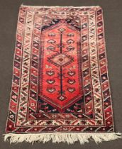 A blue and red ground Belouche rug with stylised tree of life and 2 central medallions within a