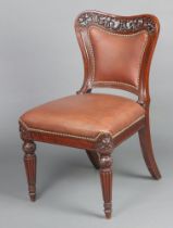 A Victorian carved and pierced mahogany standard chair, the back and seat upholstered in brown