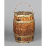 A 19th Century oak coopered barrel with swing handle 43cm h x 28cm diam.