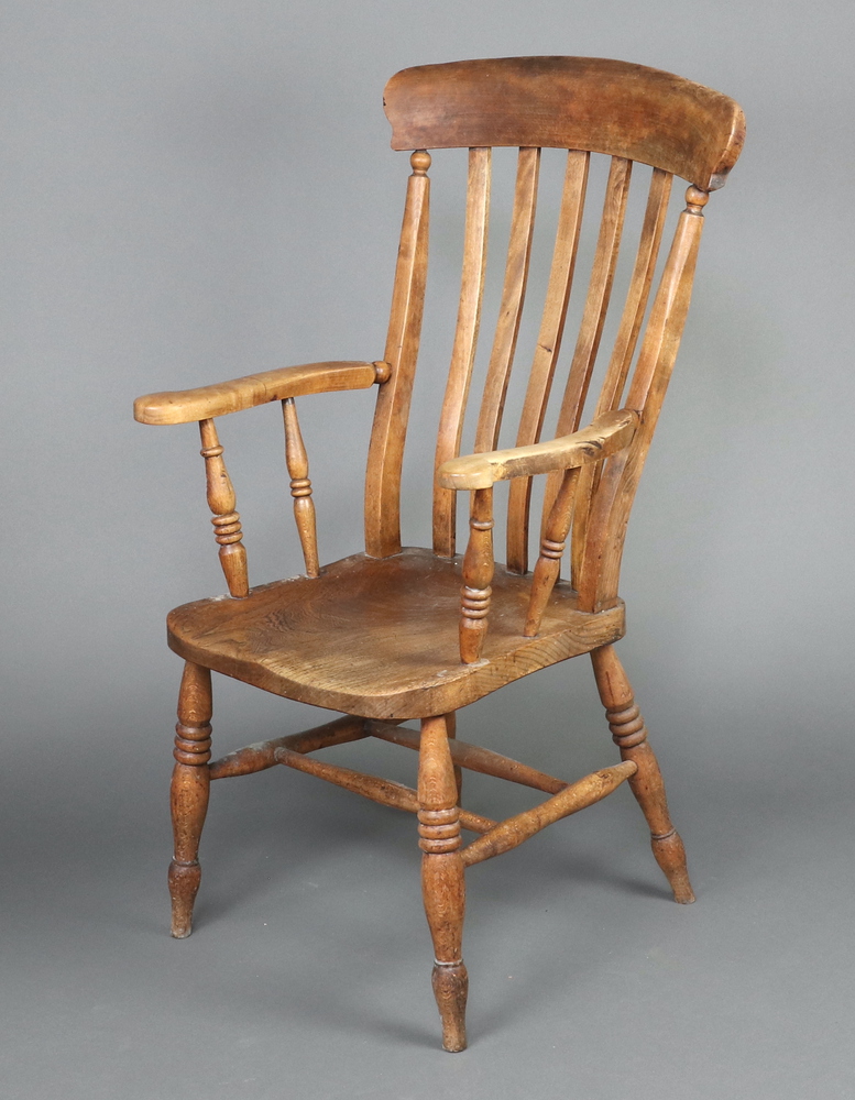 A 19th Century elm and beech comb back carver chair with solid seat 112cm h x 60cm w x 44cm d (